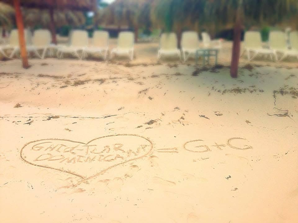 A heart with the GhidTur name on the beach beside sun loungers.